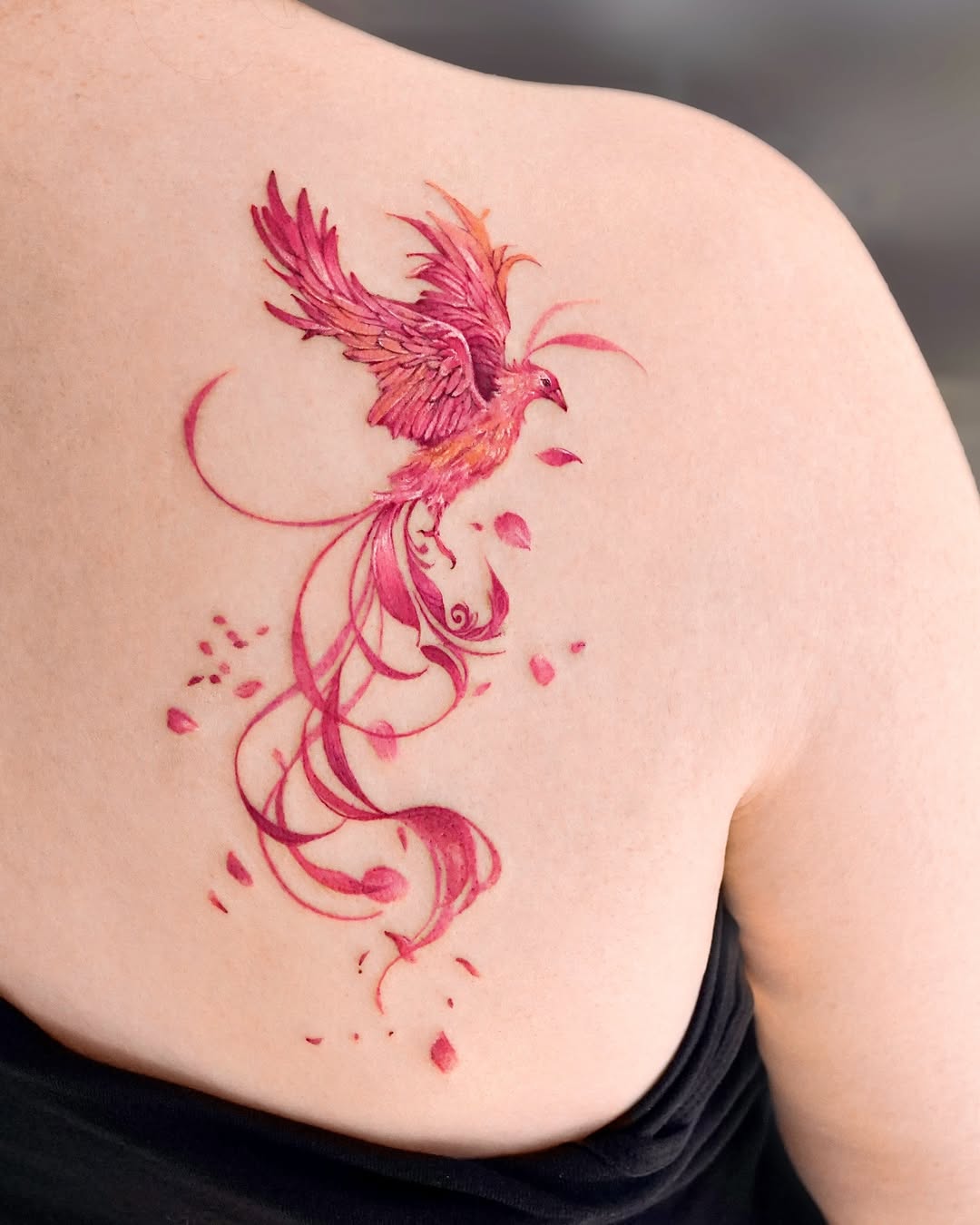 Stunning pink phoenix tattoo with flowing designs Tattoo on skin