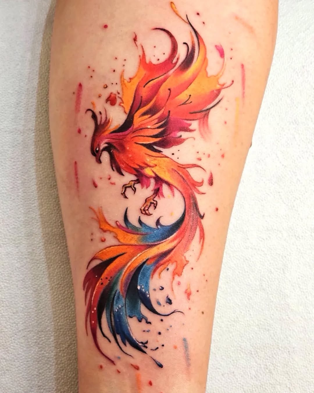 Stunning vibrant phoenix tattoo in motion. Tattoo on skin
