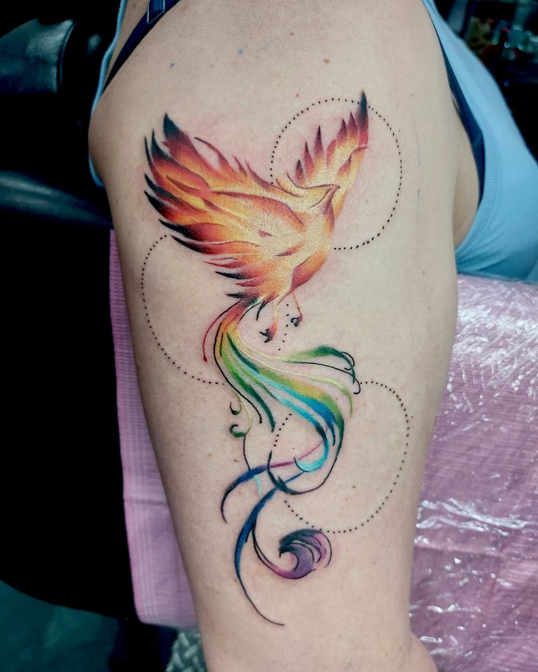 Vivid phoenix tattoo showcasing rainbow hues Tattoo on skin