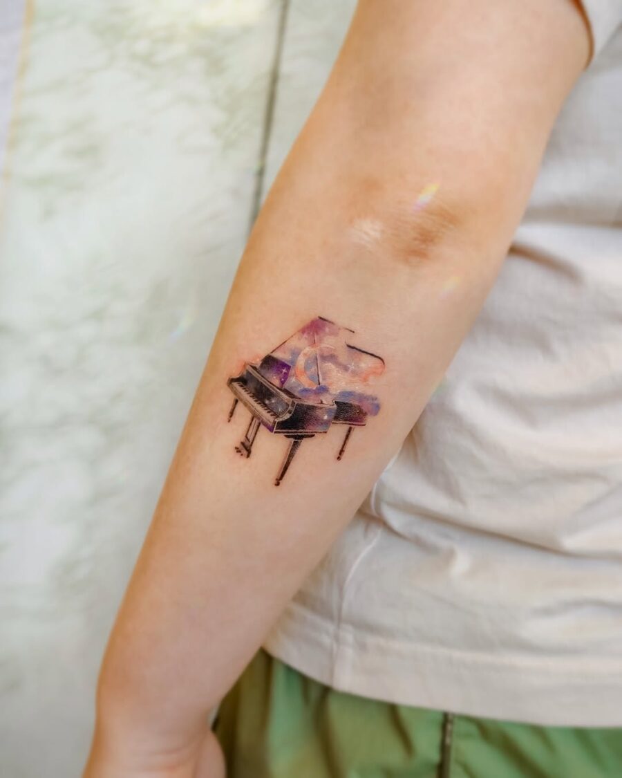 A vibrant grand piano tattoo exuding creativity Tattoo on skin