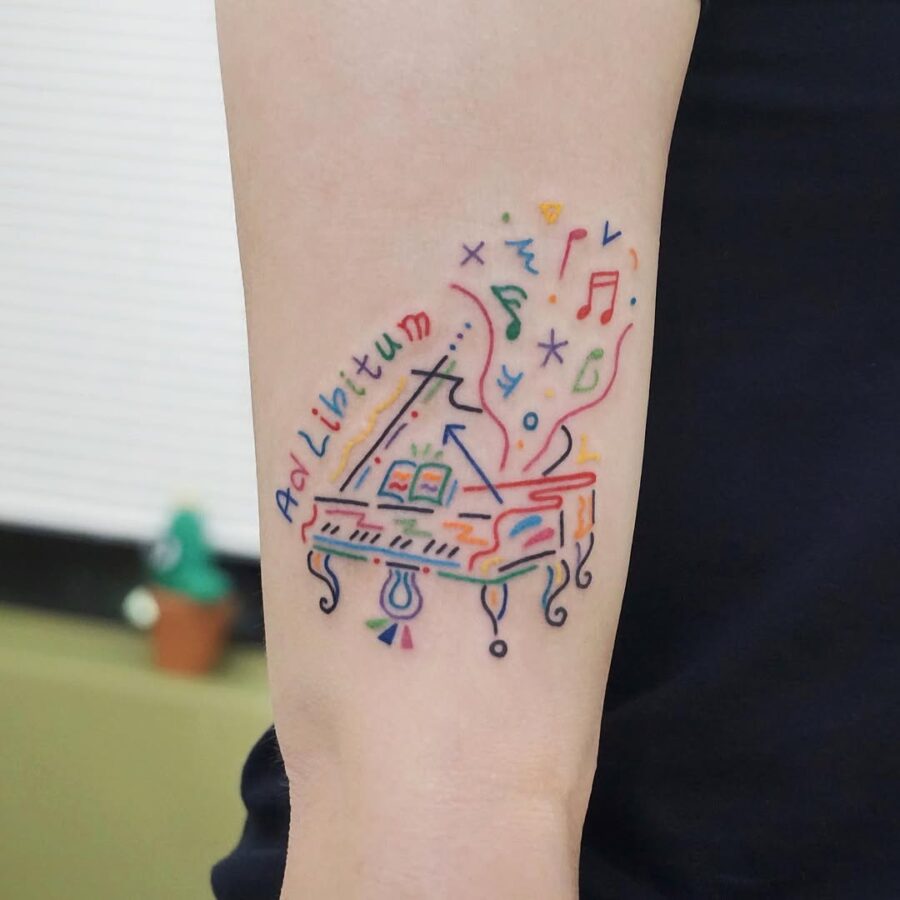 Colorful piano tattoo with musical elements Tattoo on skin
