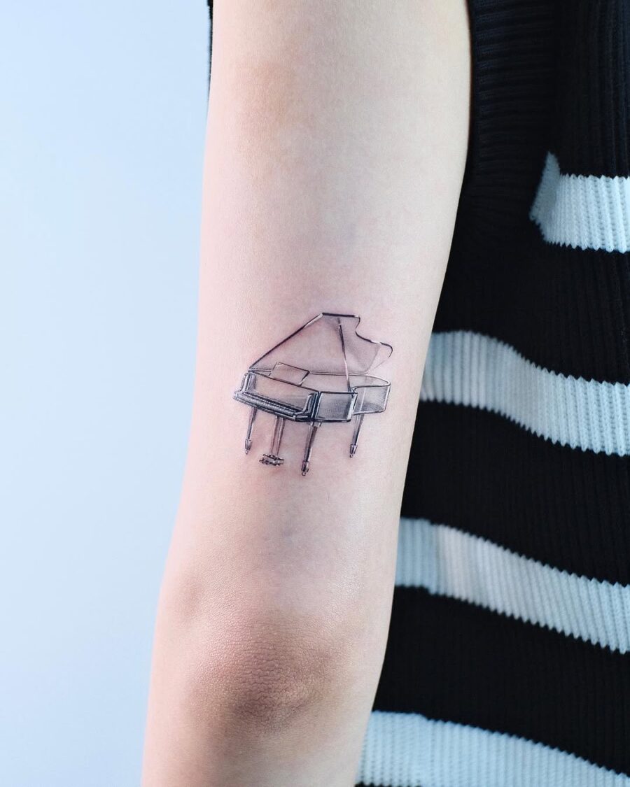 Elegant minimalist piano tattoo on forearm Tattoo on skin