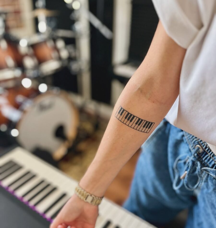 Elegant piano keys tattoo on forearm Tattoo on skin