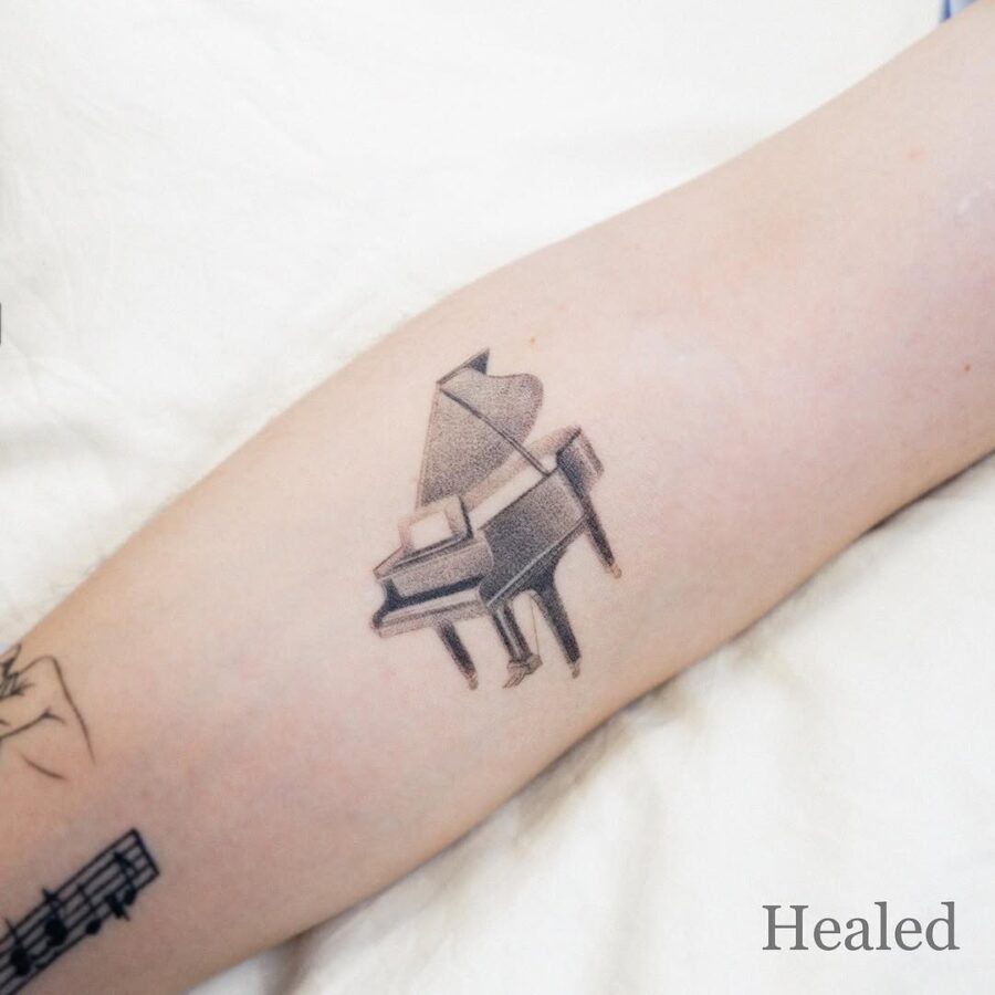 Elegant piano tattoo for music lovers Tattoo on skin