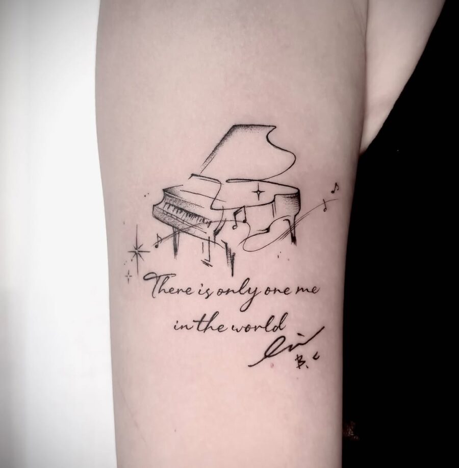 Elegant piano tattoo with a heartfelt message Tattoo on skin