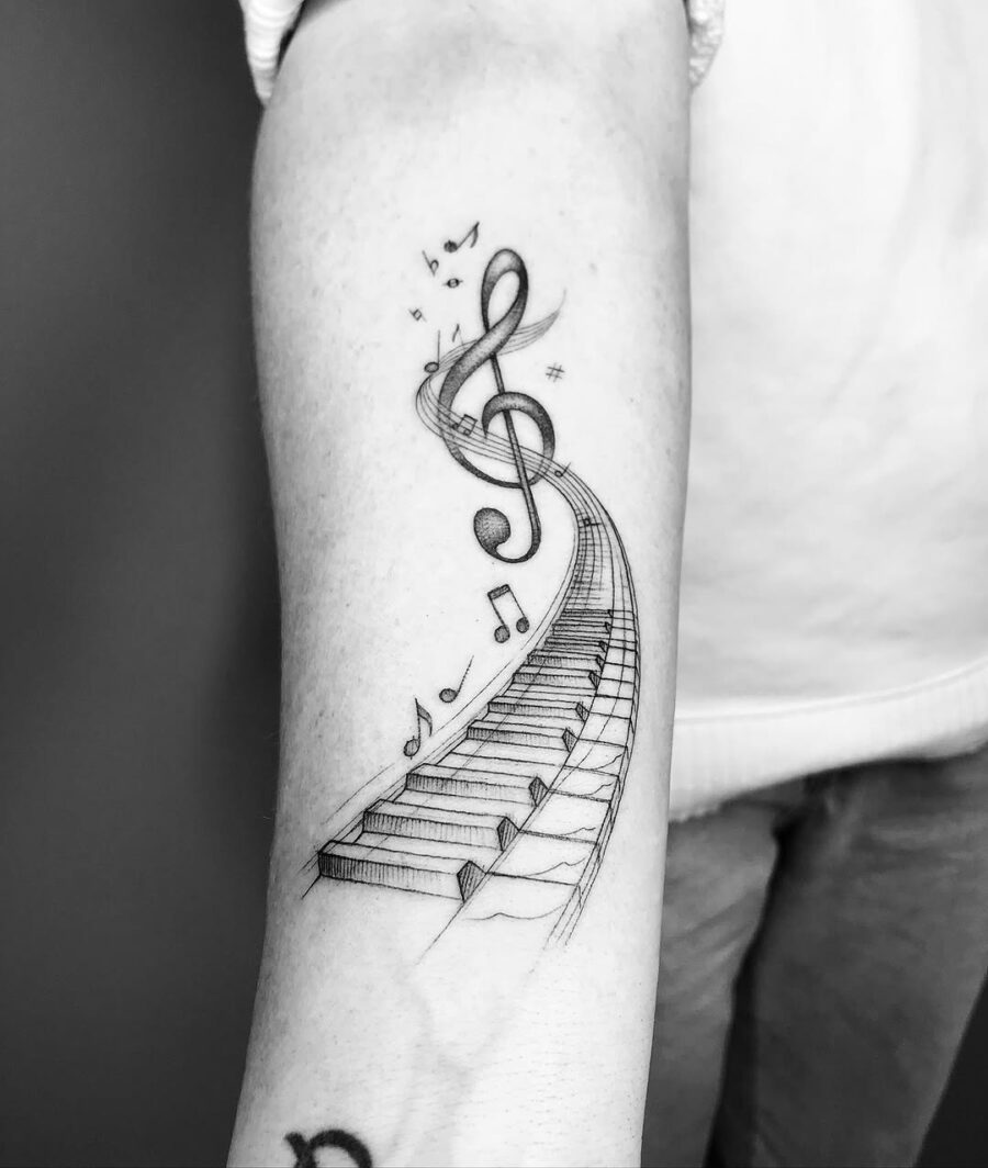 Elegant piano tattoo with musical flair Tattoo on skin