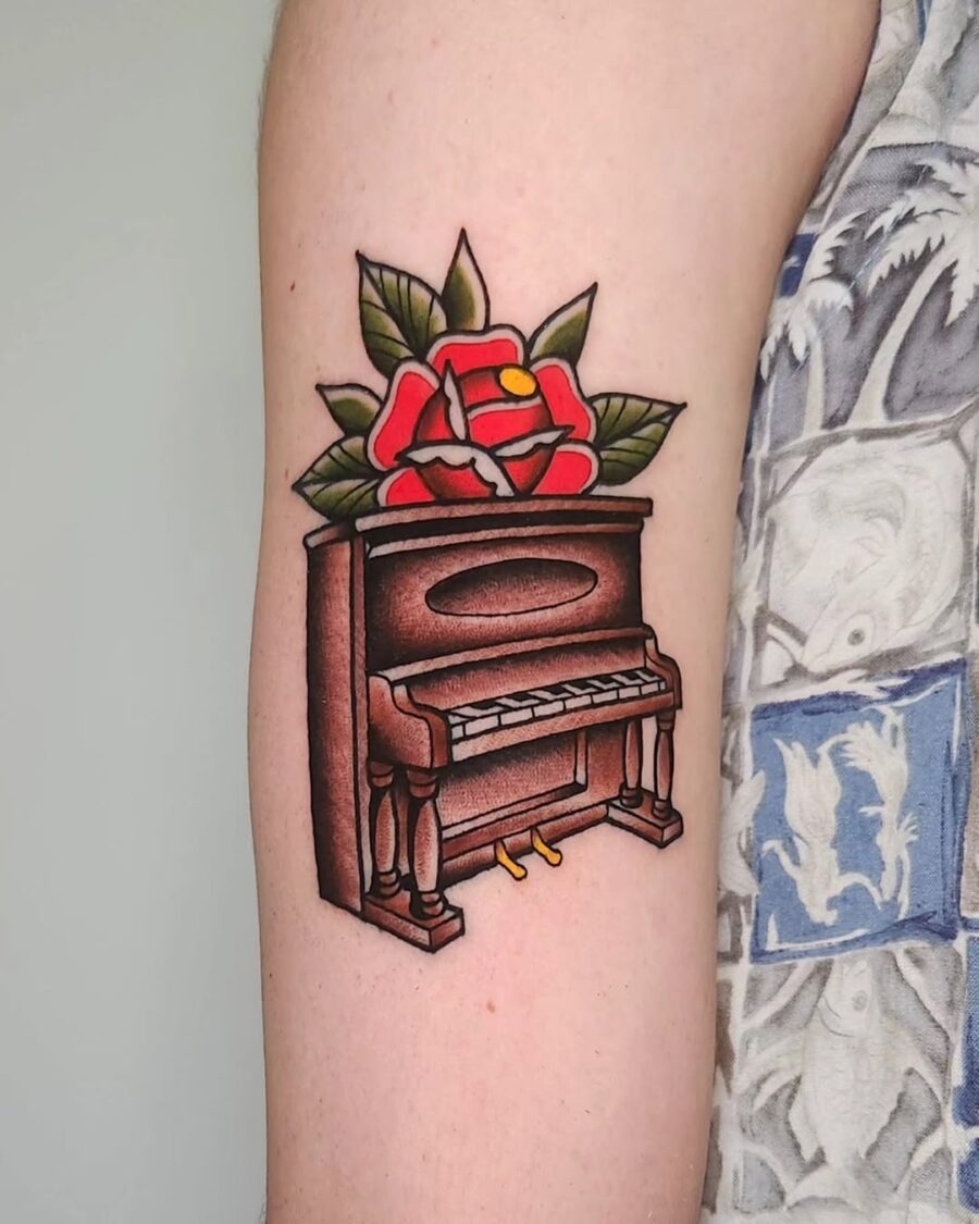 Elegant piano tattoo with vibrant floral accents Tattoo on skin