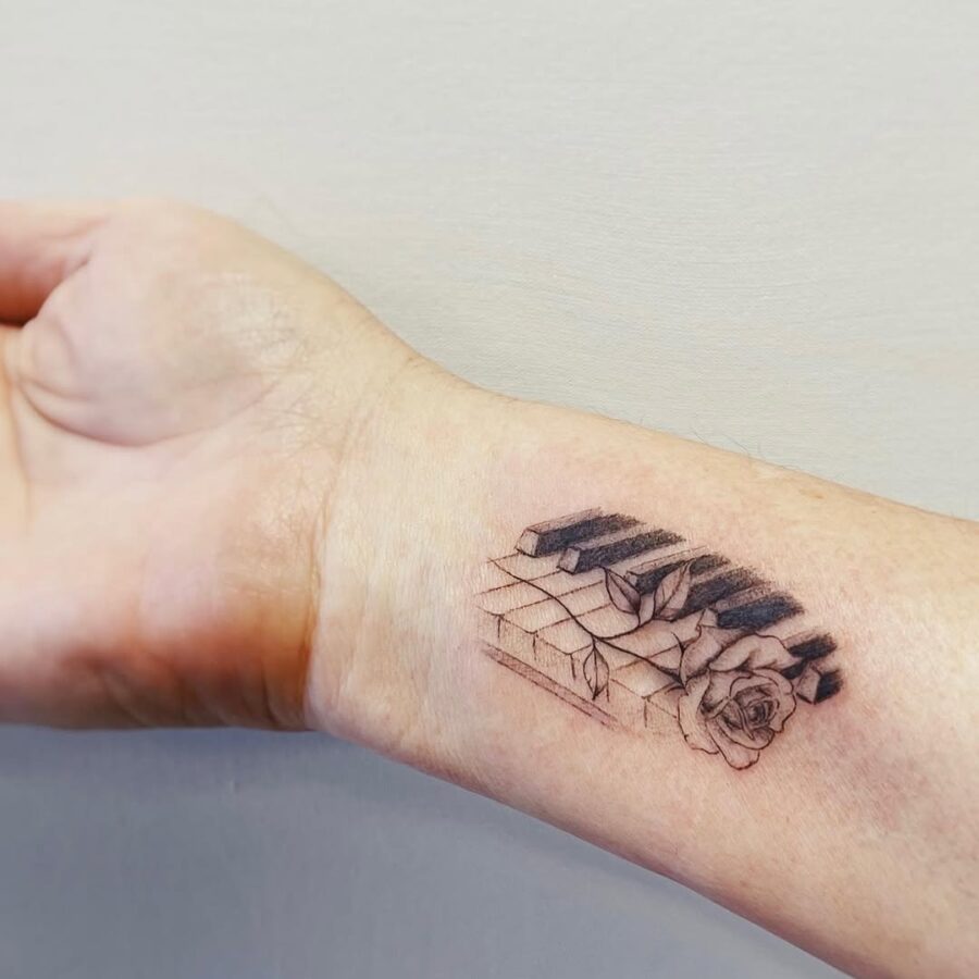Intricate piano and rose tattoo blending art Tattoo on skin