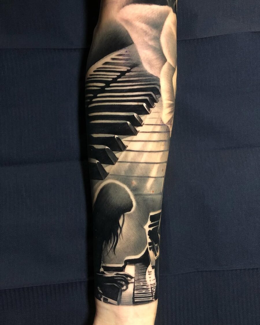 Intricate piano tattoo creating musical harmony Tattoo on skin
