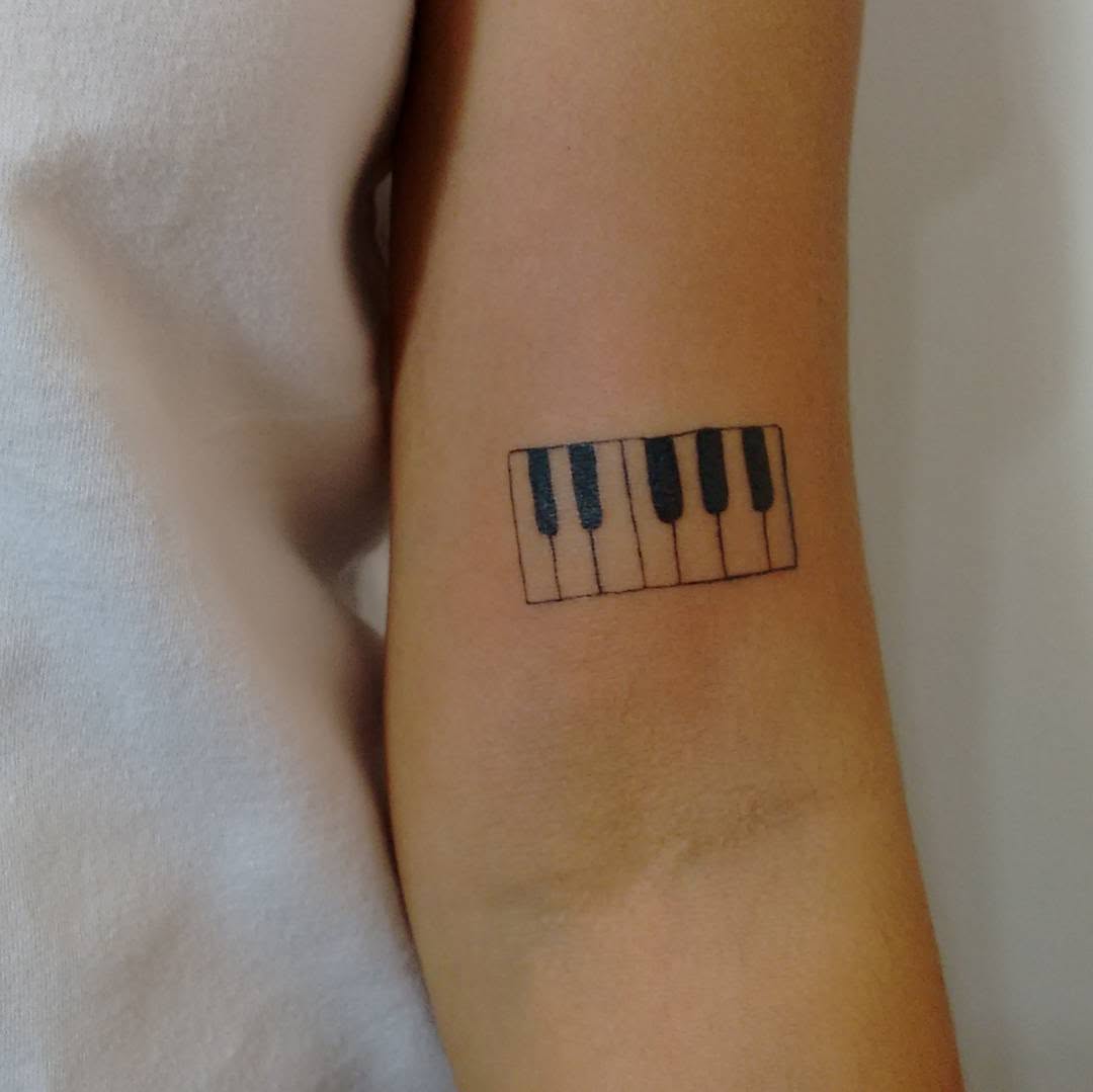 Minimalist piano tattoo on forearm Tattoo on skin