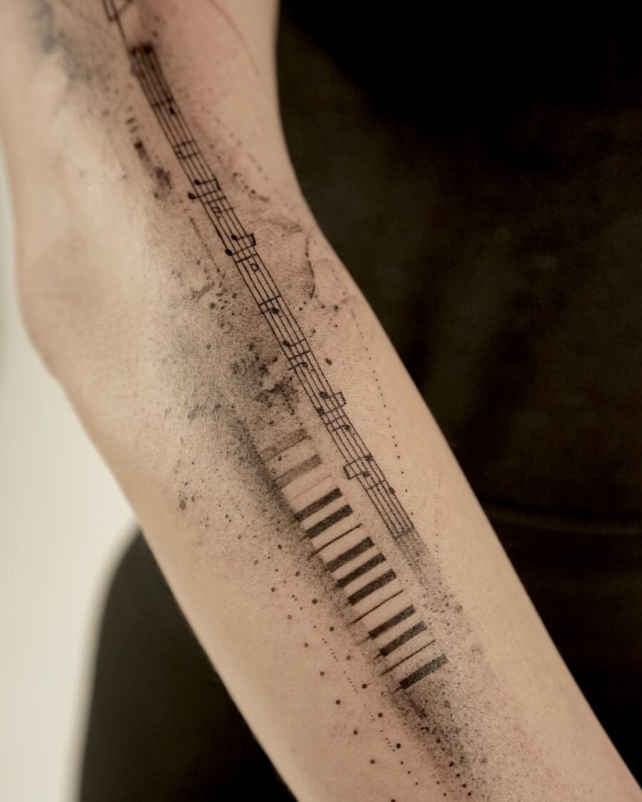 Minimalist piano tattoo with musical details Tattoo on skin