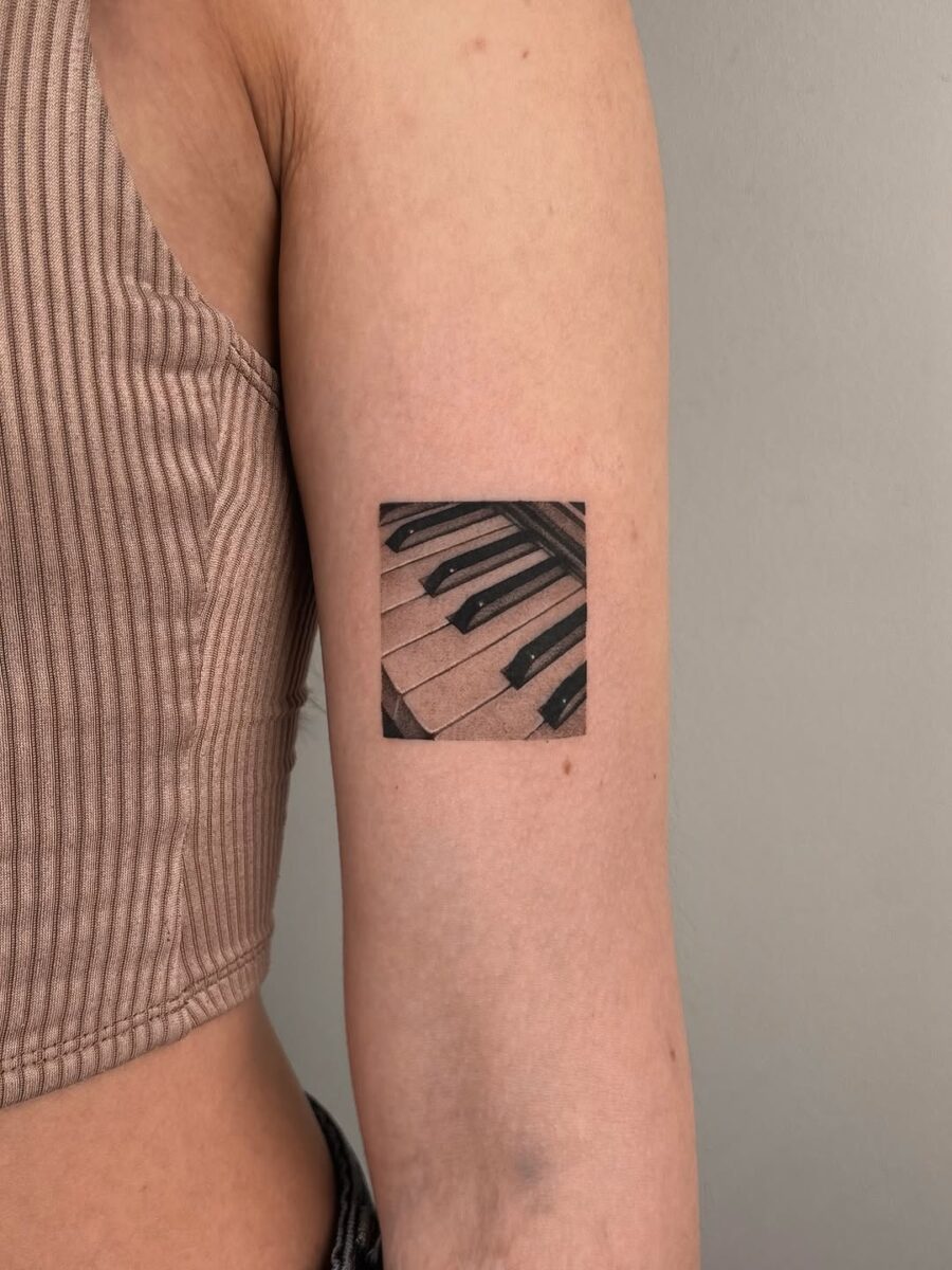 Stylish piano keys tattoo on the arm Tattoo on skin