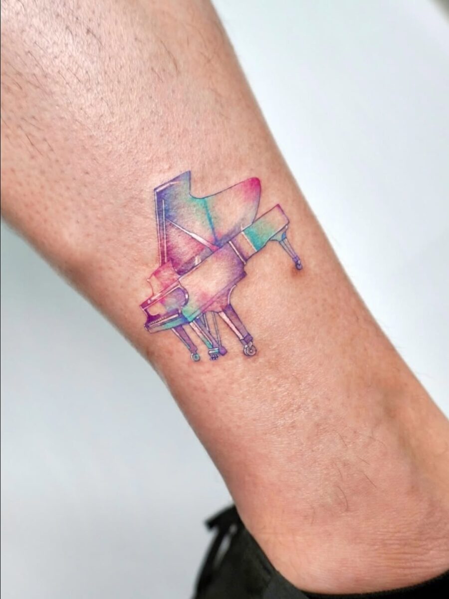 Vibrant grand piano tattoo on the leg piano tattoos