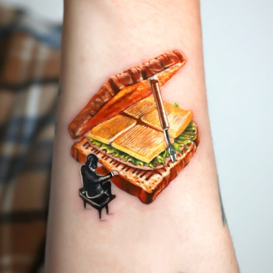 Whimsical piano sandwich tattoo design Tattoo on skin