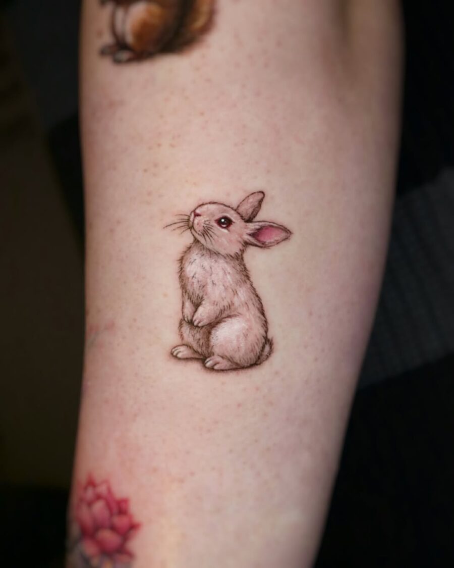 Adorable realistic rabbit tattoo on arm Tattoo on skin