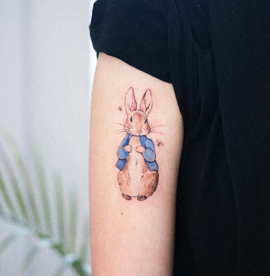 Charming rabbit tattoo in a cozy outfit Tattoo on skin