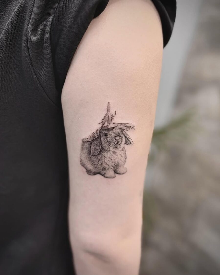 Charming rabbit tattoo with a playful hat Tattoo on skin