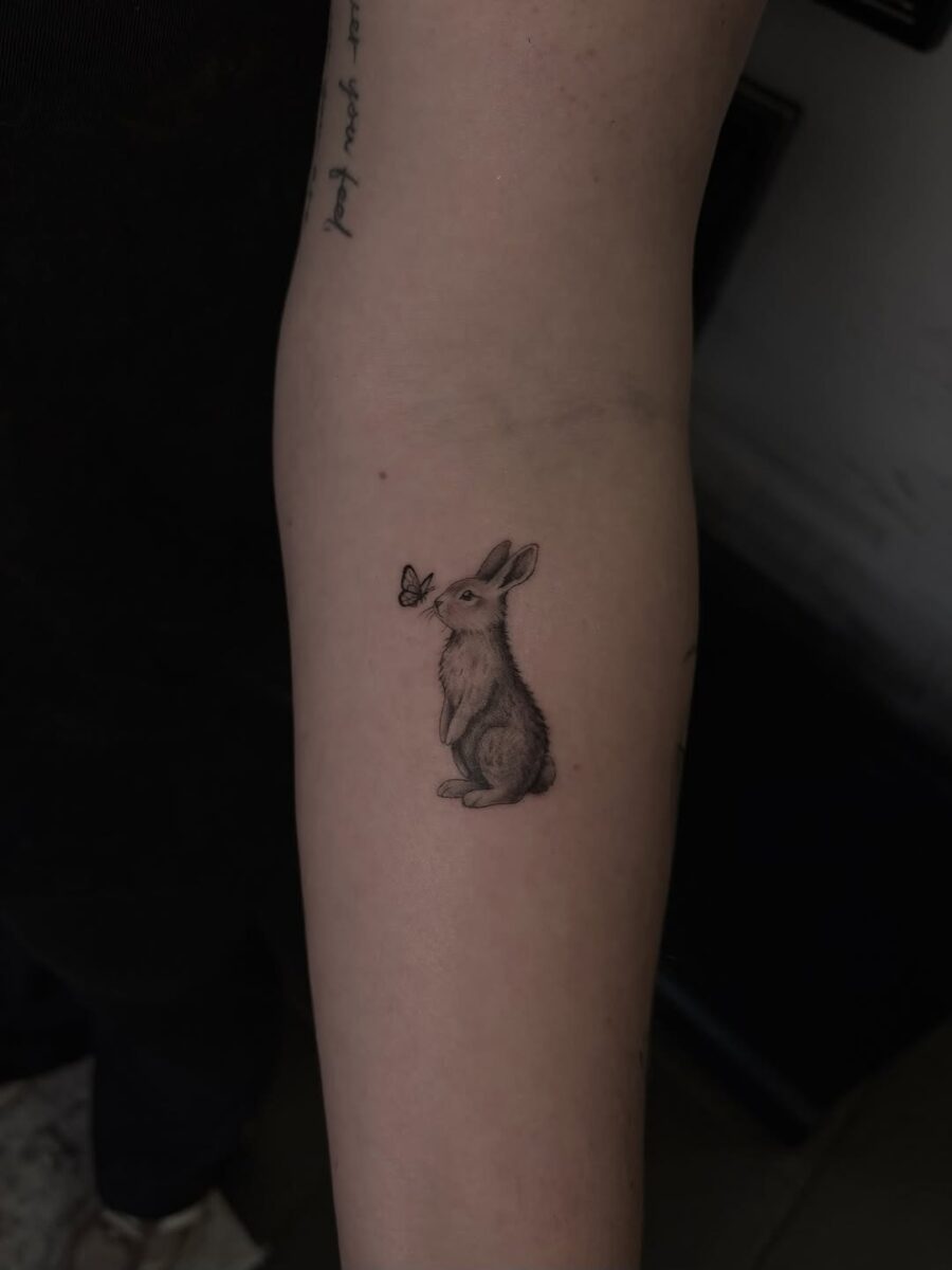 Charming rabbit tattoo with butterfly companion Tattoo on skin