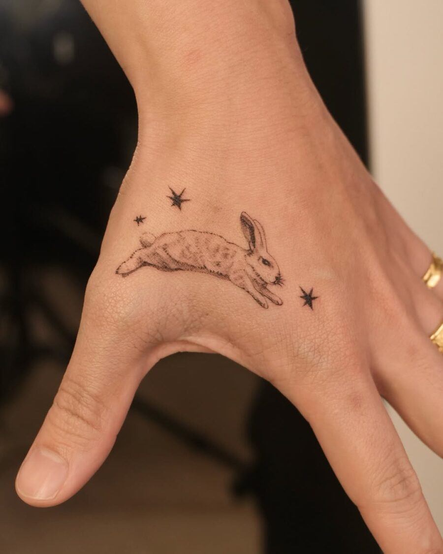 Whimsical rabbit tattoo with celestial accents Tattoo on skin