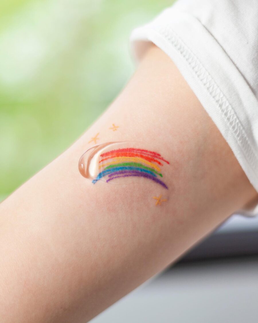 Vibrant Rainbow Baby Tattoo on Child's Arm Tattoo on skin