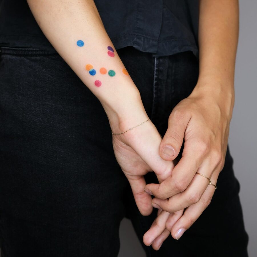 Colorful dot tattoos symbolizing joy and remembrance Tattoo on skin