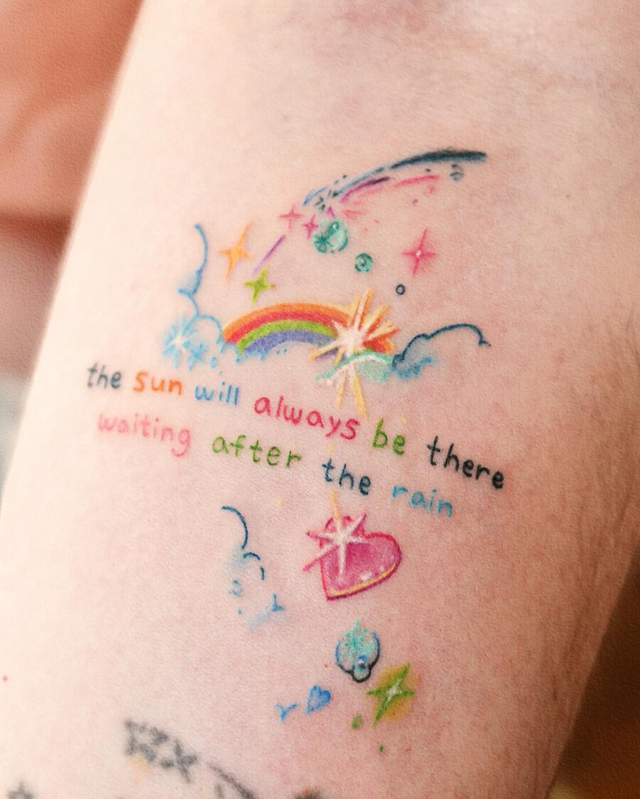 Colorful rainbow baby tattoo with a hopeful message Tattoo on skin