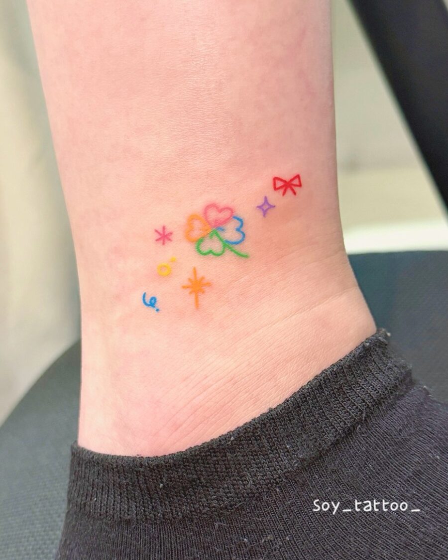 Delicate Rainbow Flower Tattoo With Joyful Accents Tattoo on skin