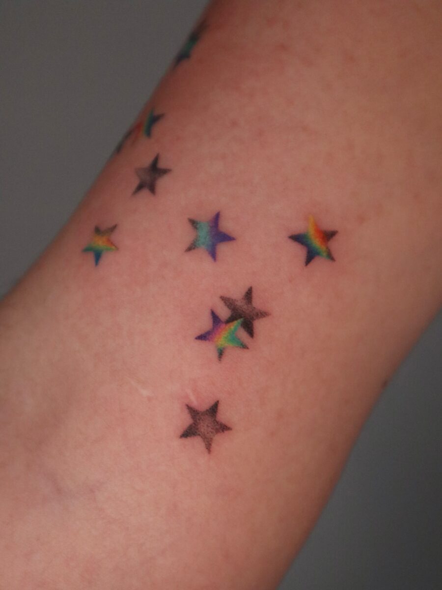 Symbolic colorful stars represent rainbow babies Tattoo on skin