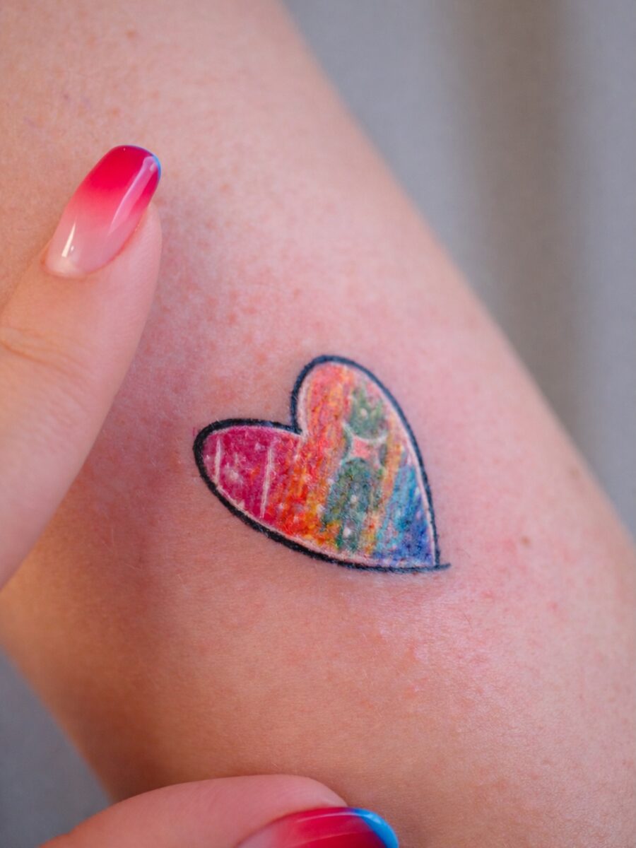 Vibrant heart tattoo celebrating rainbow babies Tattoo on skin