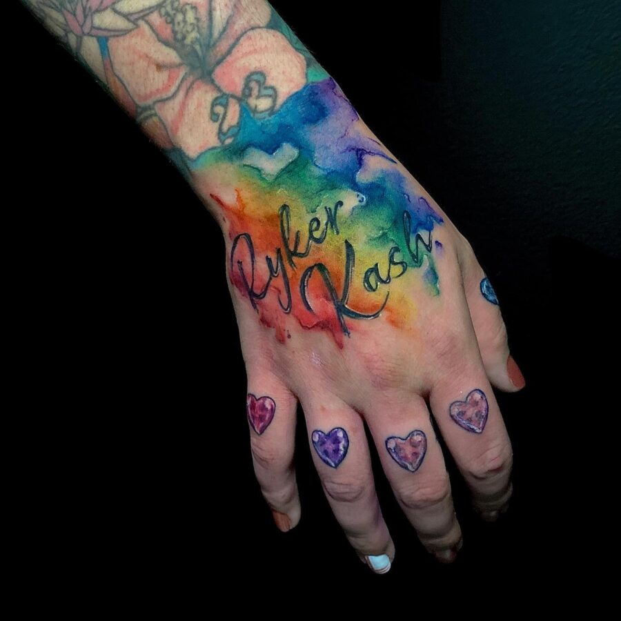 Vibrant rainbow baby tattoo on a hand. Tattoo on skin