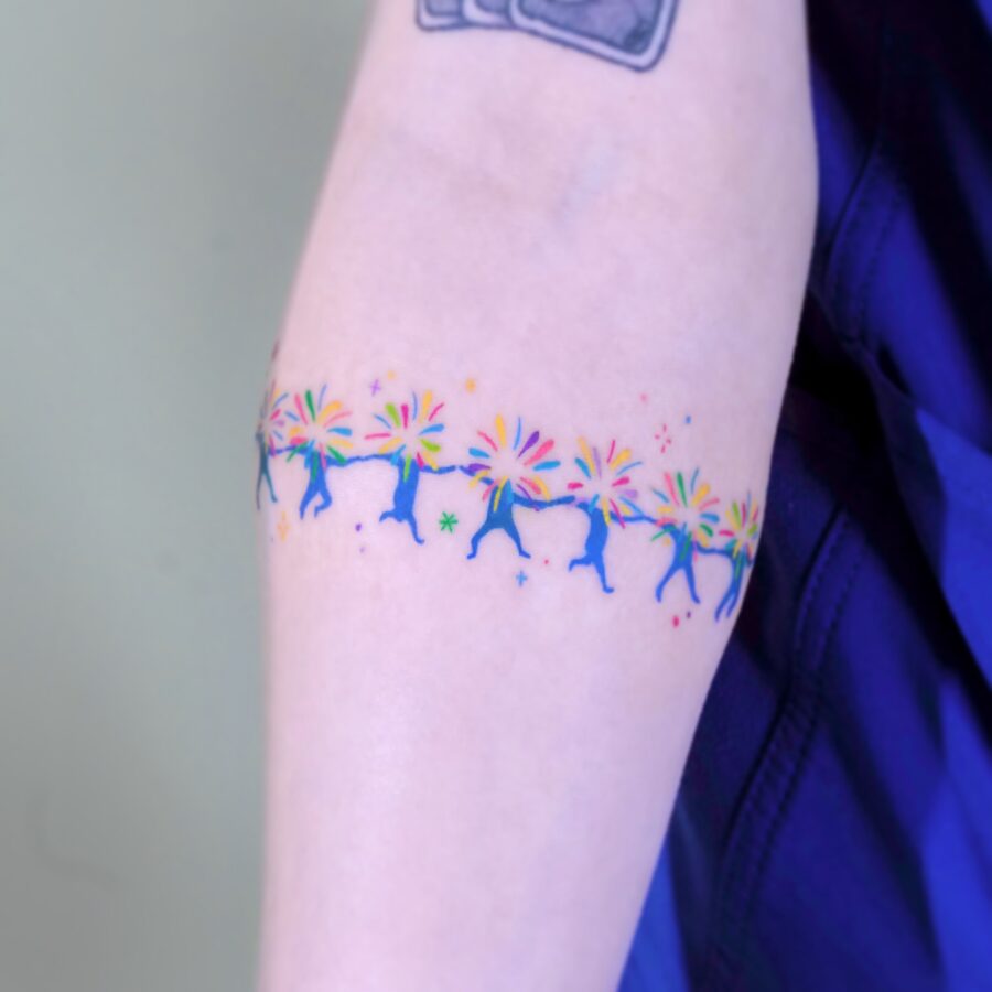Vibrant rainbow baby tattoo on arm skin Tattoo on skin
