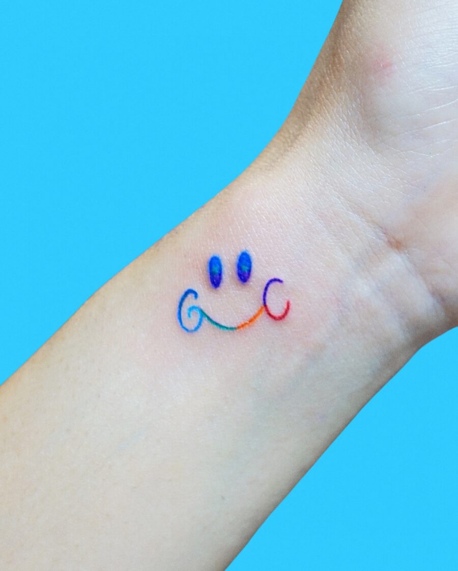 Vibrant Smiley Rainbow Baby Tattoo Design Tattoo on skin