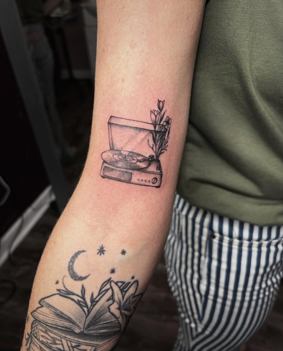 Charming record player tattoo with floral accents Tattoo on skin