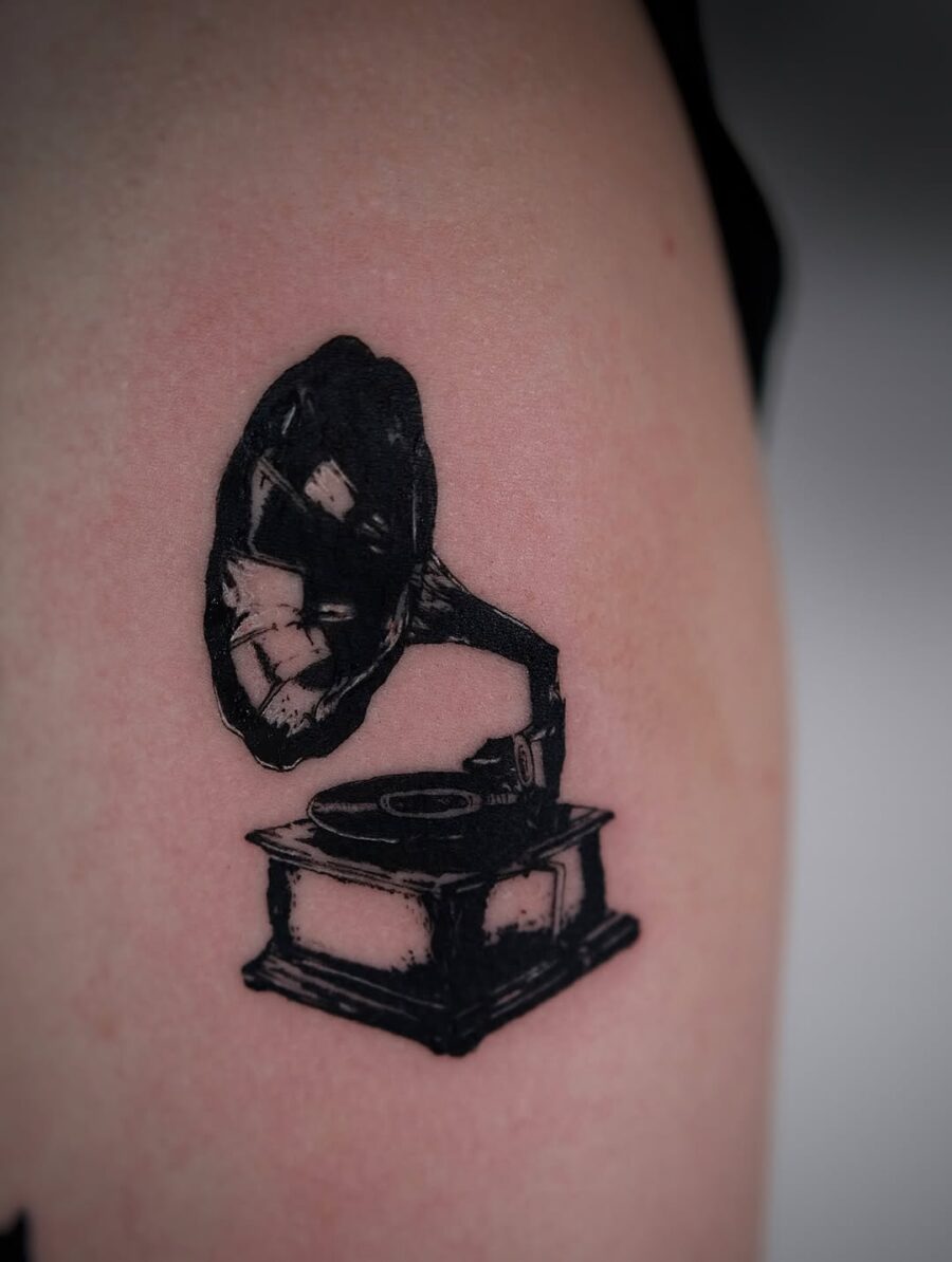 Classic record player tattoo in bold black ink Tattoo on skin