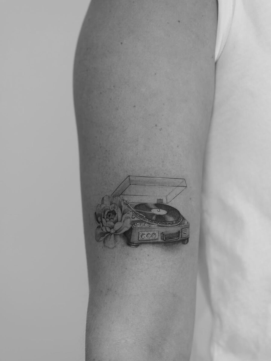Elegant record player tattoo with floral elements Tattoo on skin