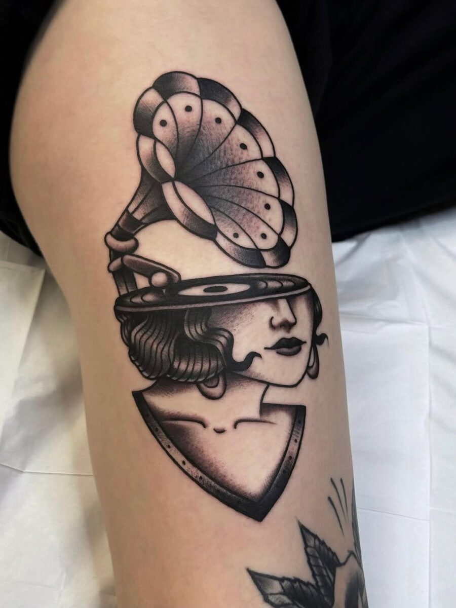 Elegant vintage tattoo of a gramophone lady Tattoo on skin