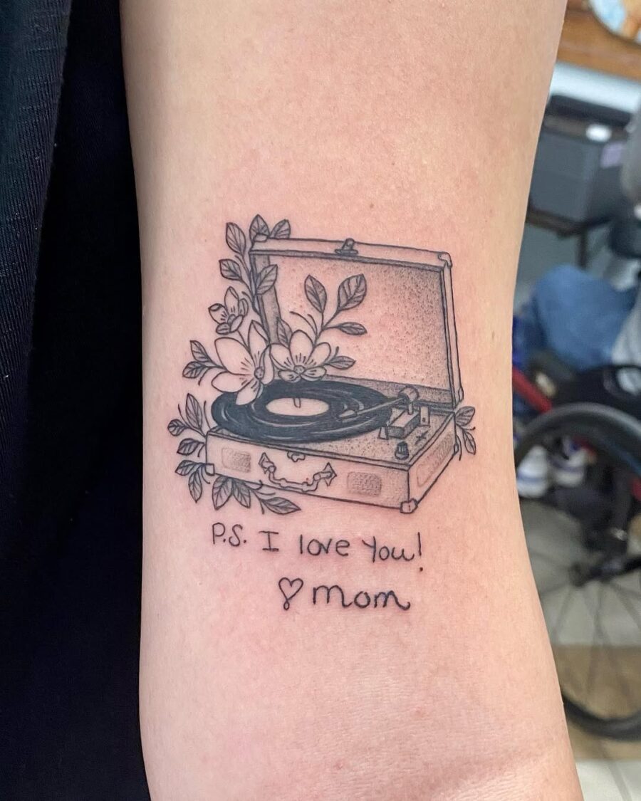 Heartfelt record player tattoo with floral elements Tattoo on skin