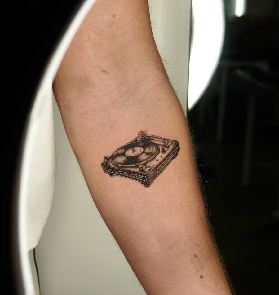 Sleek record player tattoo on forearm Tattoo on skin