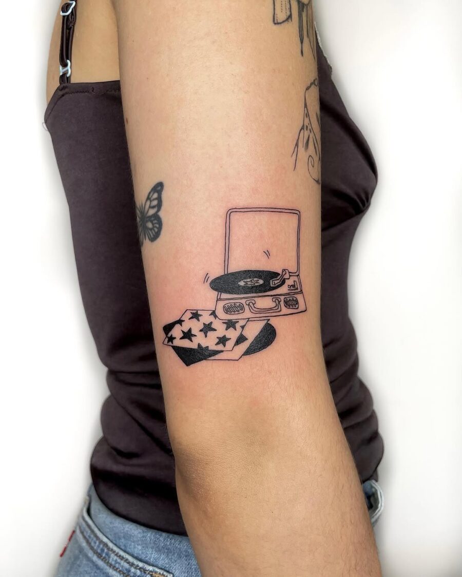 Stylish record player with star-themed details Tattoo on skin