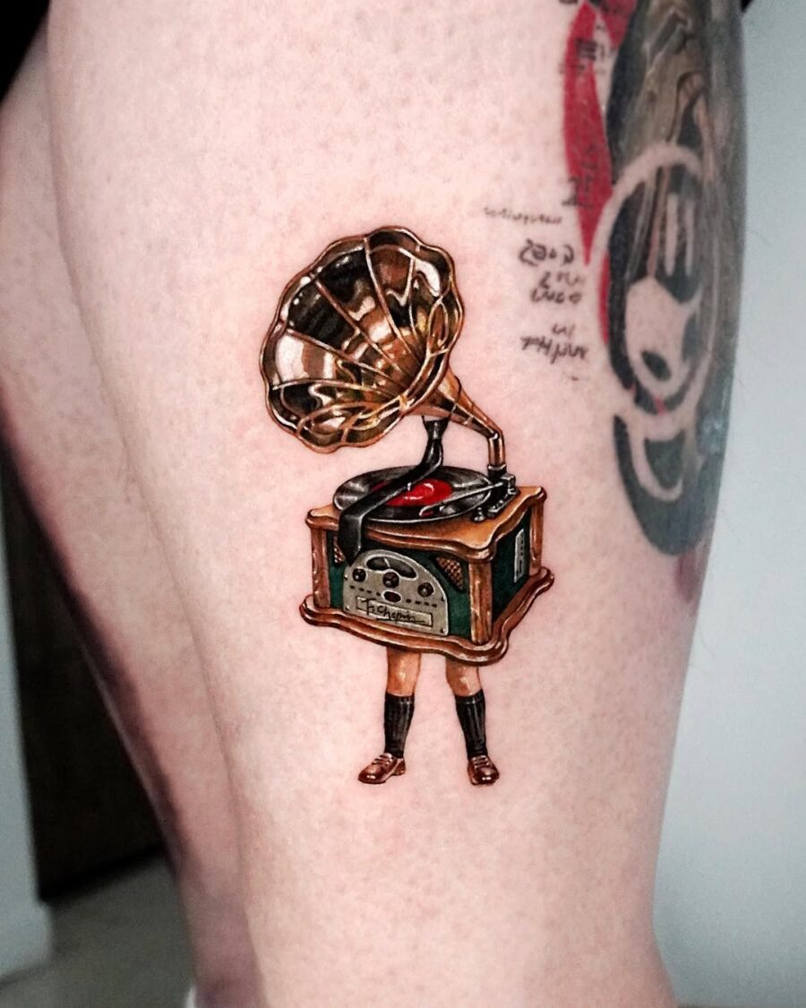 Vintage gramophone tattoo with a creative twist Tattoo on skin