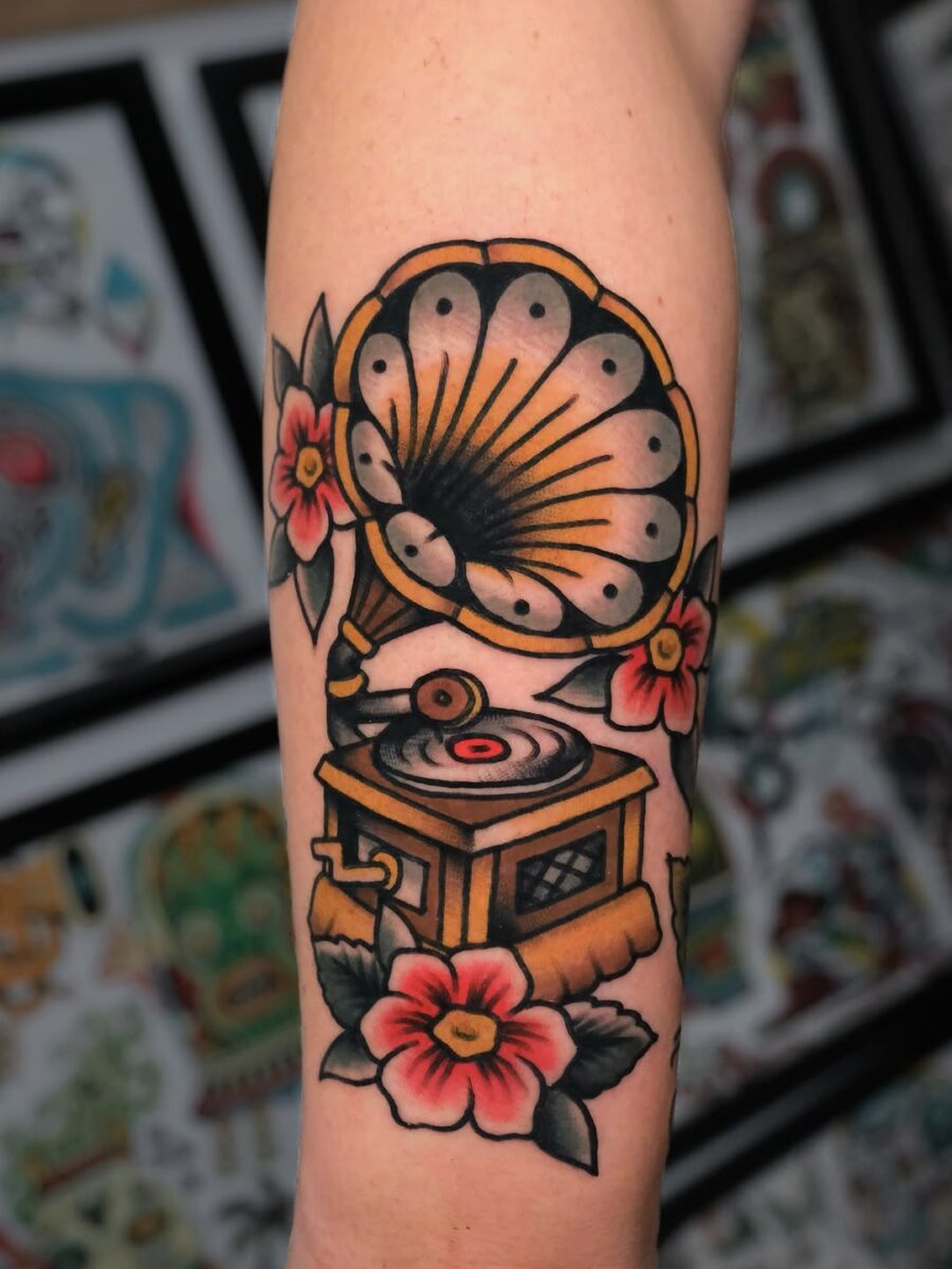 Vintage record player with floral embellishments Tattoo on skin