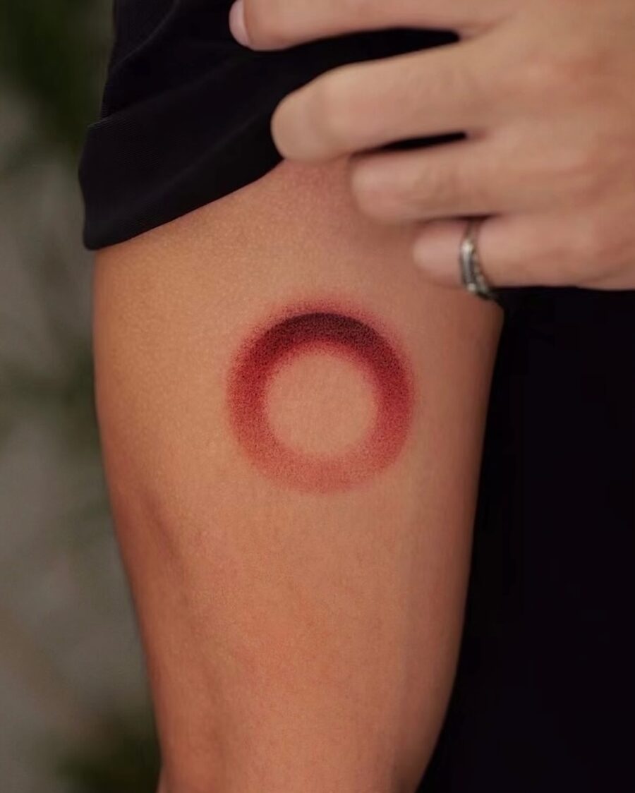 Bold Red Circle Tattoo on Arm Tattoo on skin