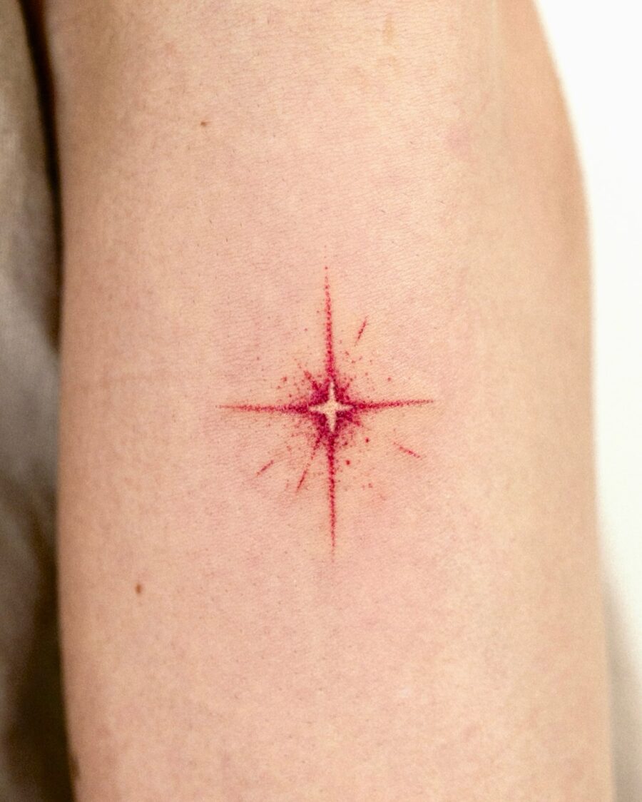 Bold red star tattoo on soft skin Tattoo on skin