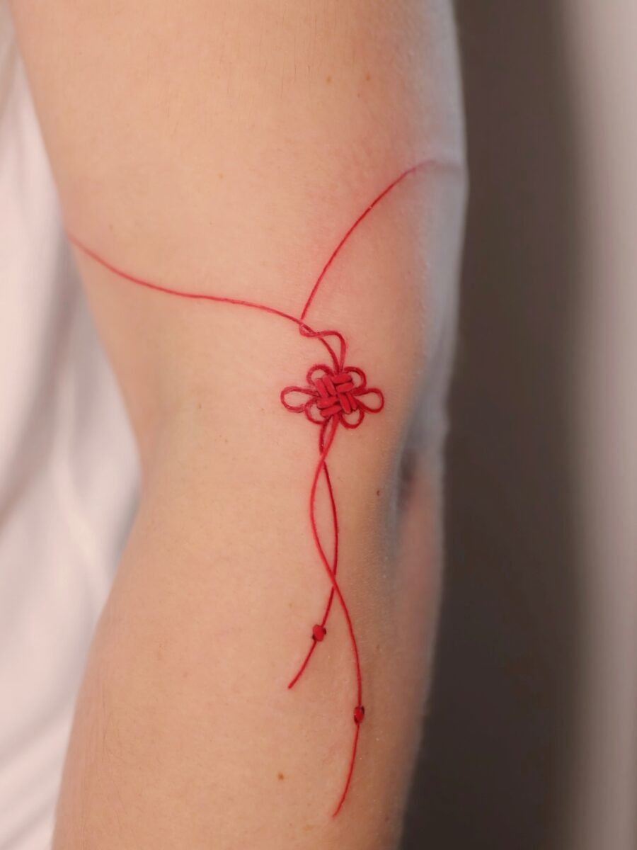 Delicate red ink flower tattoo concept Tattoo on skin