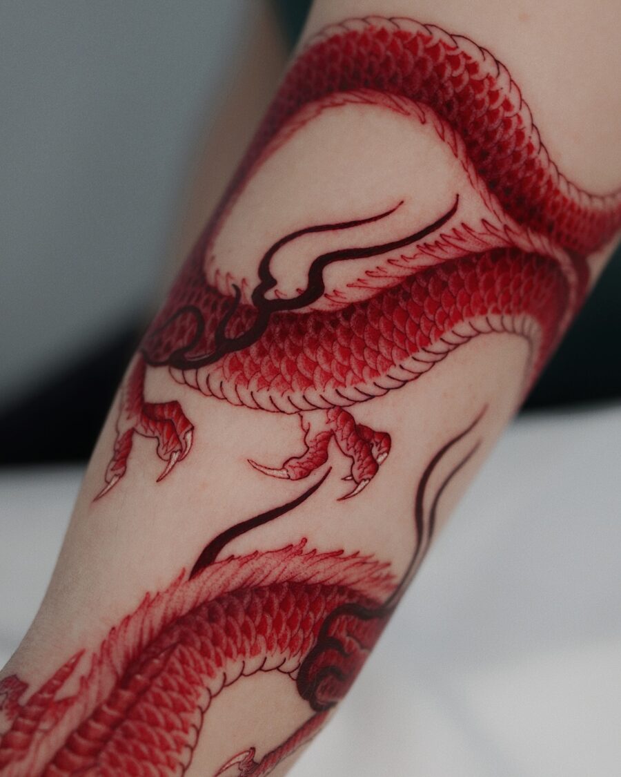 Intricate red ink dragon tattoo detail Tattoo on skin