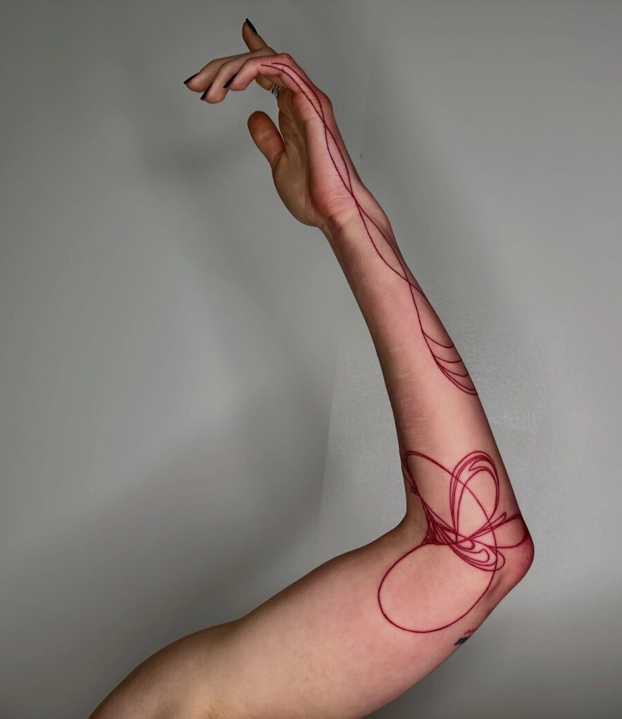 Sleek and modern red ink tattoo design Tattoo on skin