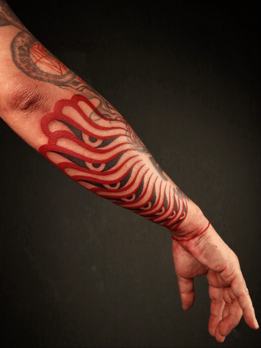 Striking Red Ink Tattoo on Forearm red ink tattoos