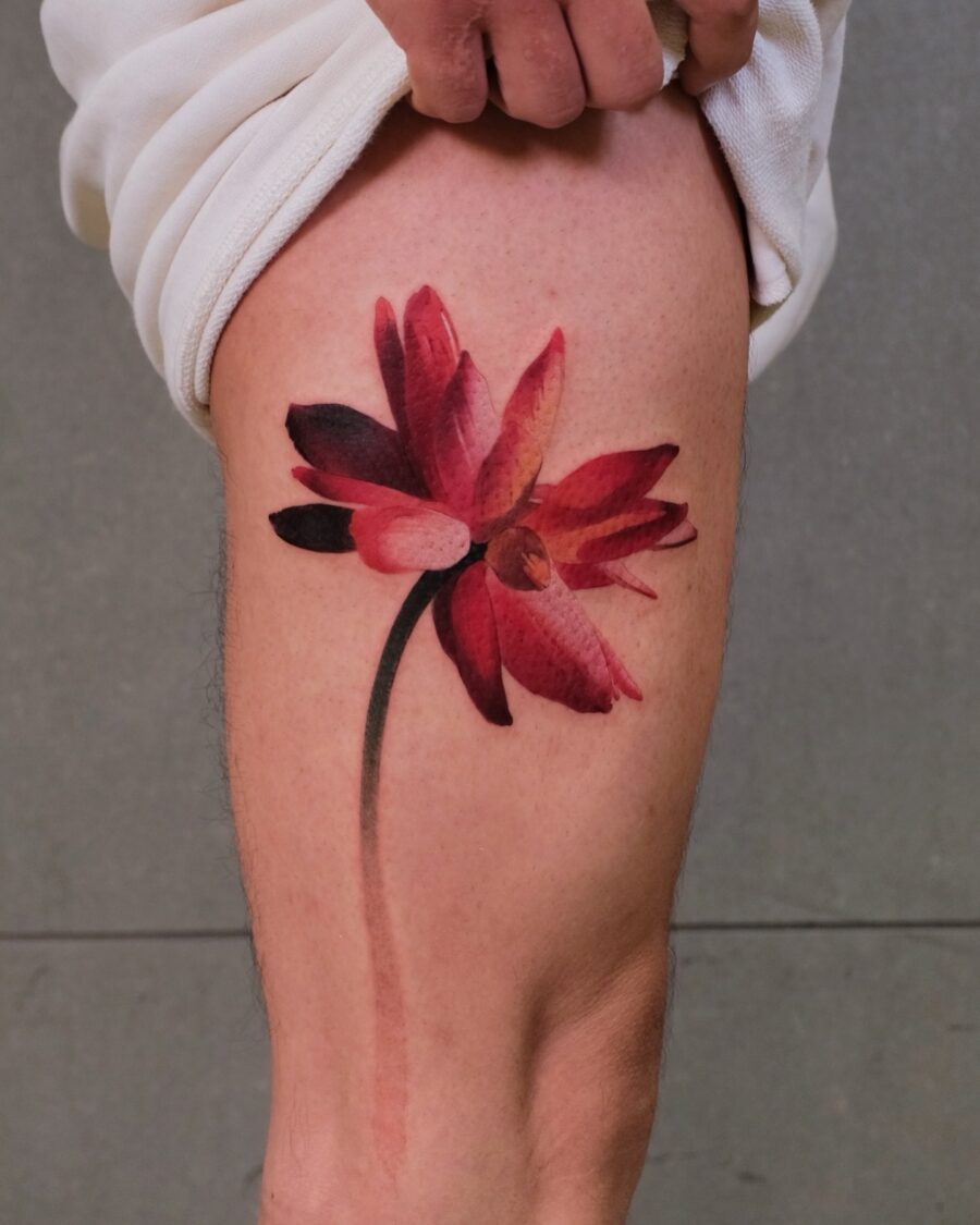 Stunning red flower tattoo bringing life. Tattoo on skin