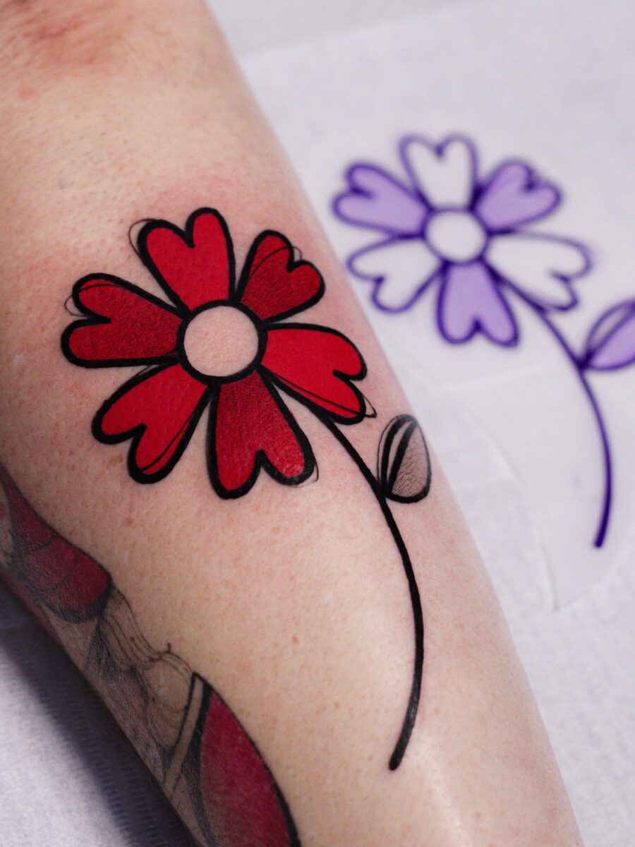 Vibrant red flower tattoo on the arm Tattoo on skin