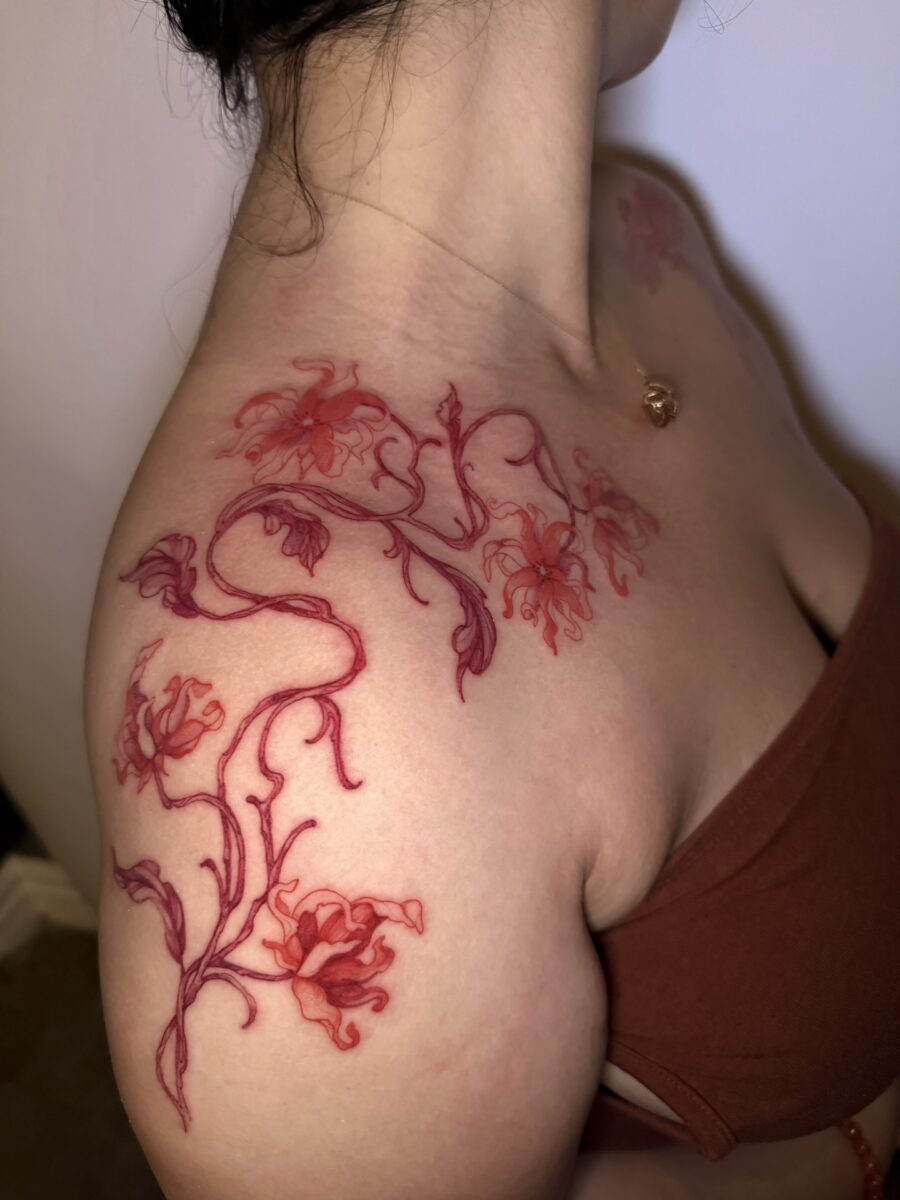 Vibrant Red Ink Floral Tattoo on the Shoulder Tattoo on skin